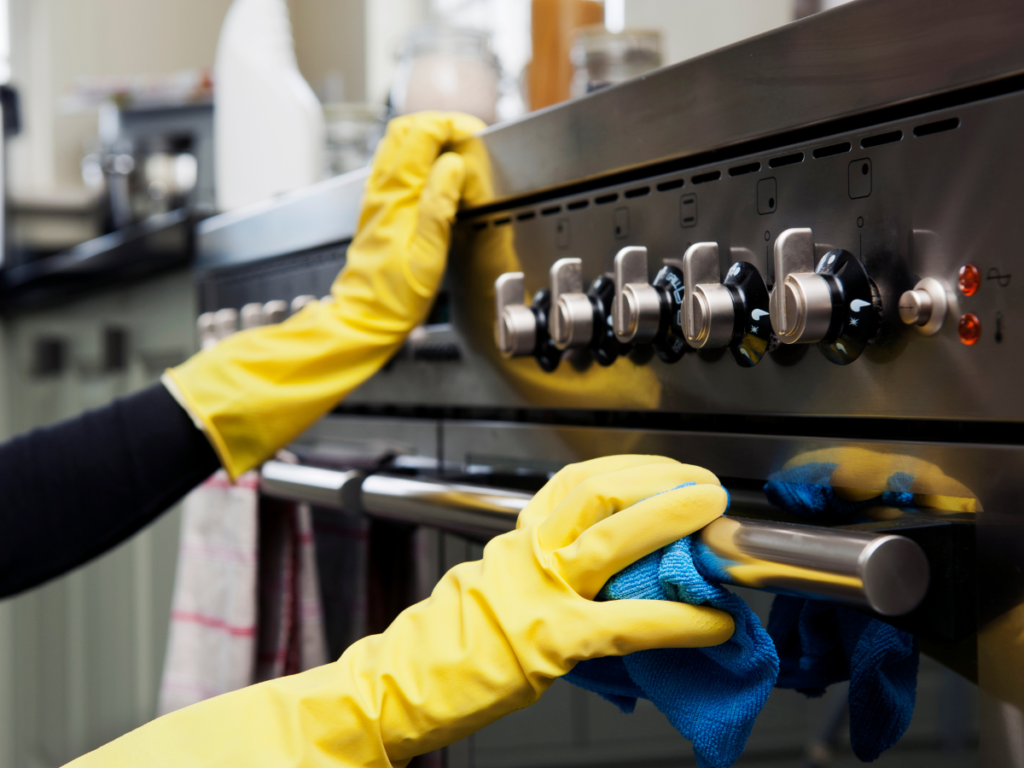 cleaning stainless steel appliances with protective gloves