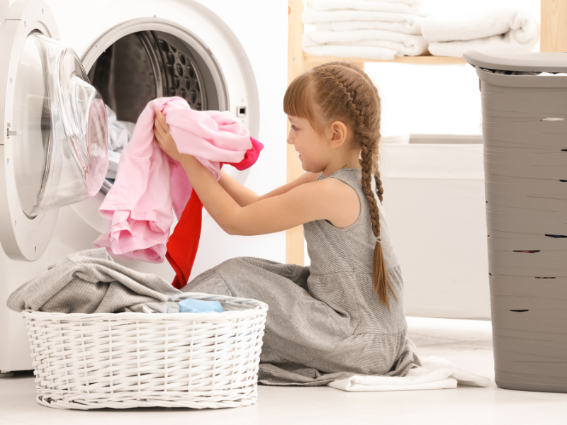 young girl helping do laundry 
