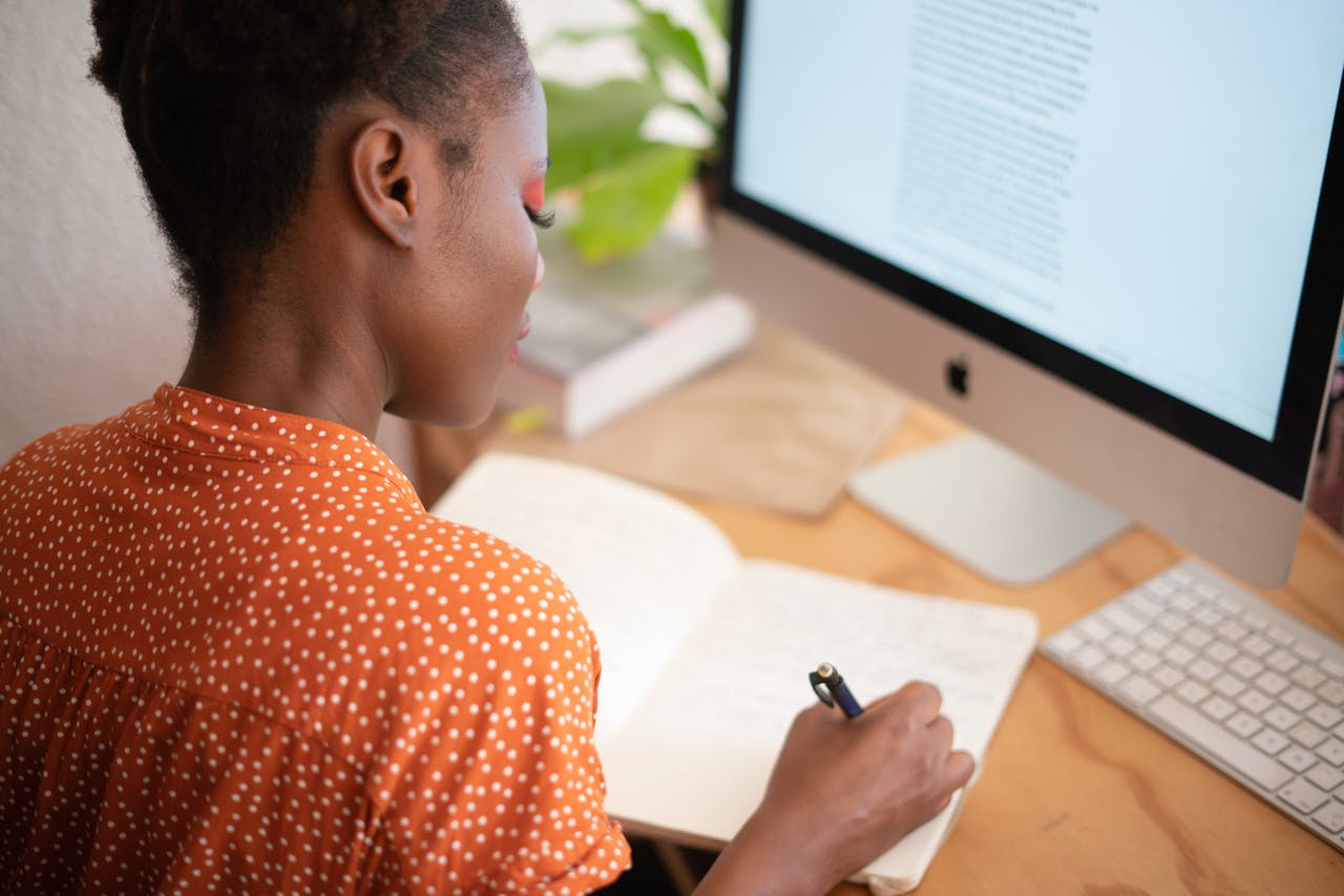 woman in orange outfit working from home
