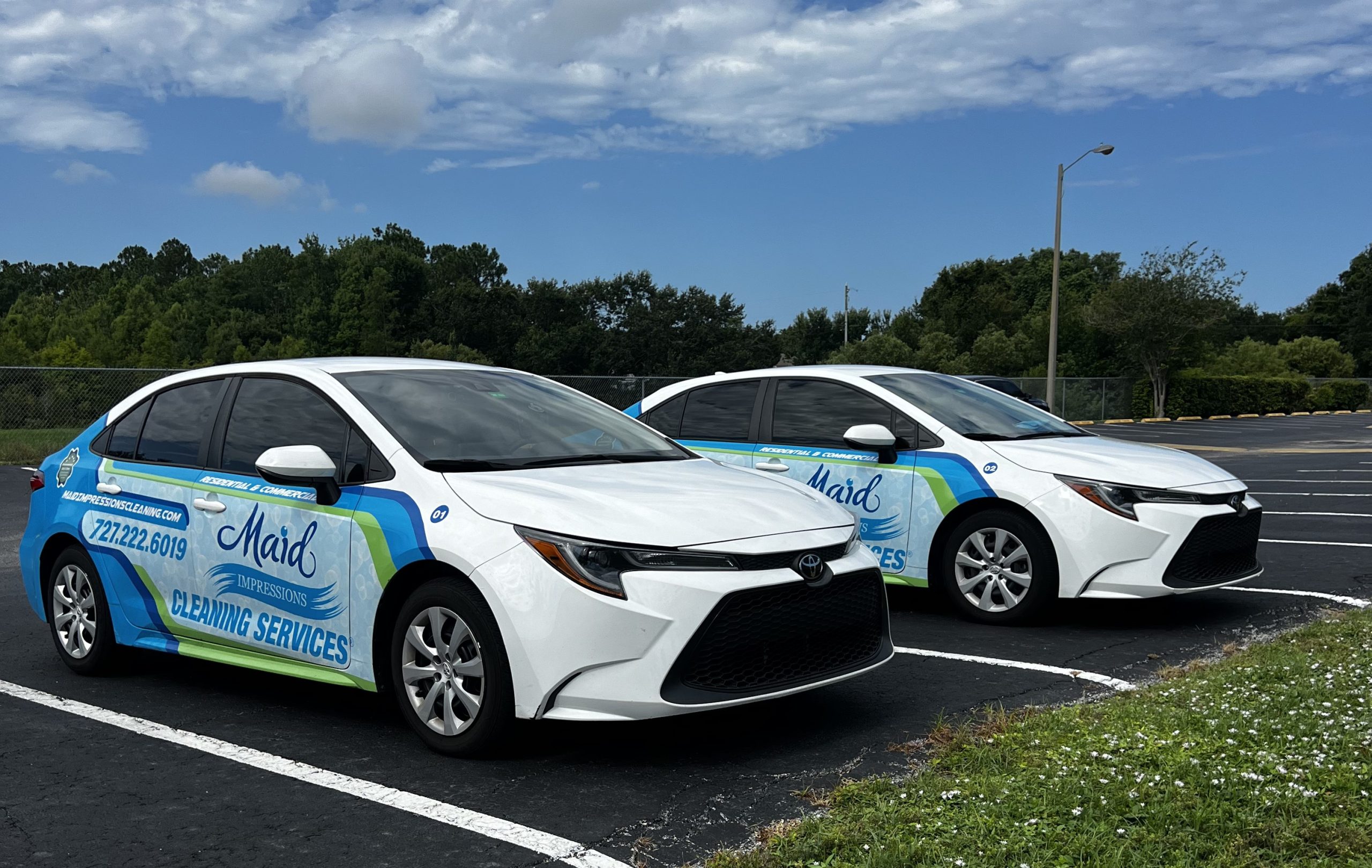Maid Impressions branded cars parked in parking lot